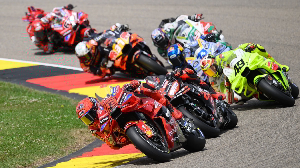 | Photo: AP/Robert Michael via dpa : Marc Marquez from Spain from the Ducati Lenovo Team leads the field during the MotoGP race, German Grand Prix, at the Sachsenring circuit, in Hohenstein-Ernstthal, Germany, Sunday July 13, 2025.
