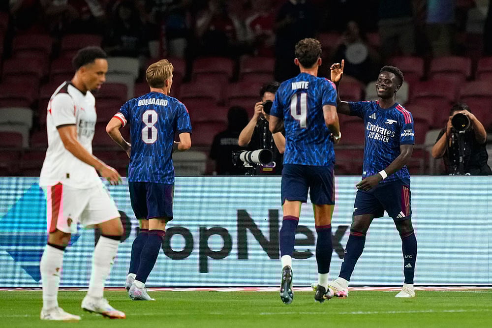 | Photo: AP/Vincent Thian : Singapore Soccer Arsenal AC Milan