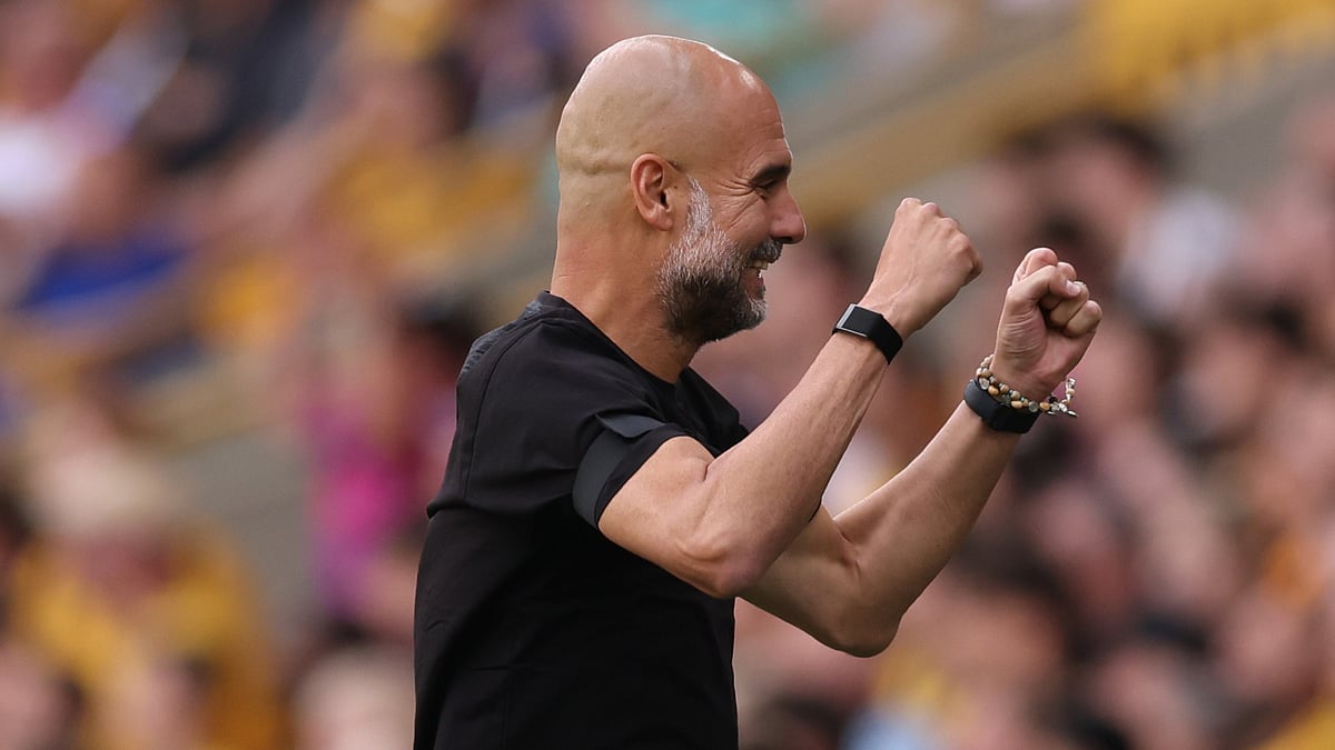Pep Guardiola celebrates during Manchester City's win at Wolves