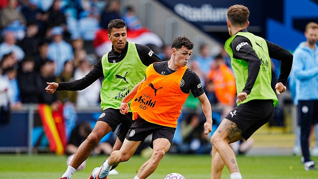 Peter Byrne/PA via AP : Manchester City's Phil Foden, centre, and Rodri during a training session at the City Football Academy, Manchester.
