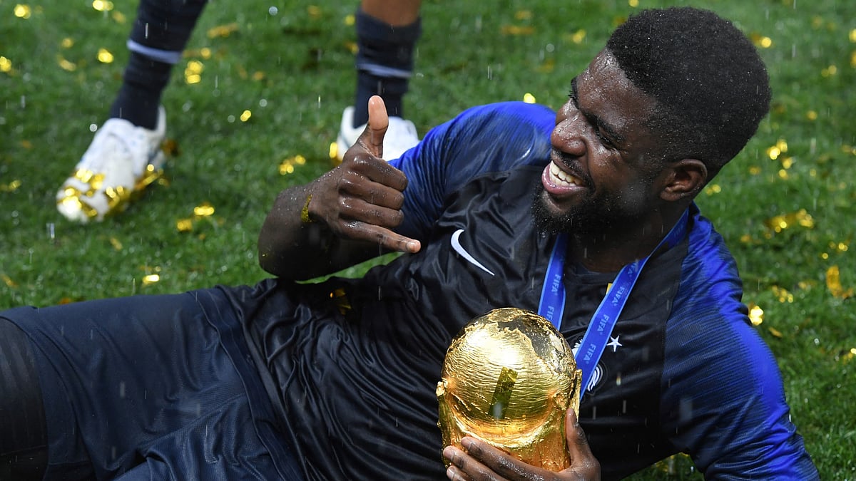 Samuel Umtiti poses with the World Cup trophy