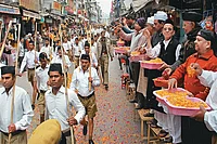 | Photo: PTI : Muslim-Hindu: Muslims shower flowers on RSS cadres outside the shrine of Sufi Saint Khwaja Moinuddin Chisti in Ajmer 
on October 3, 2013