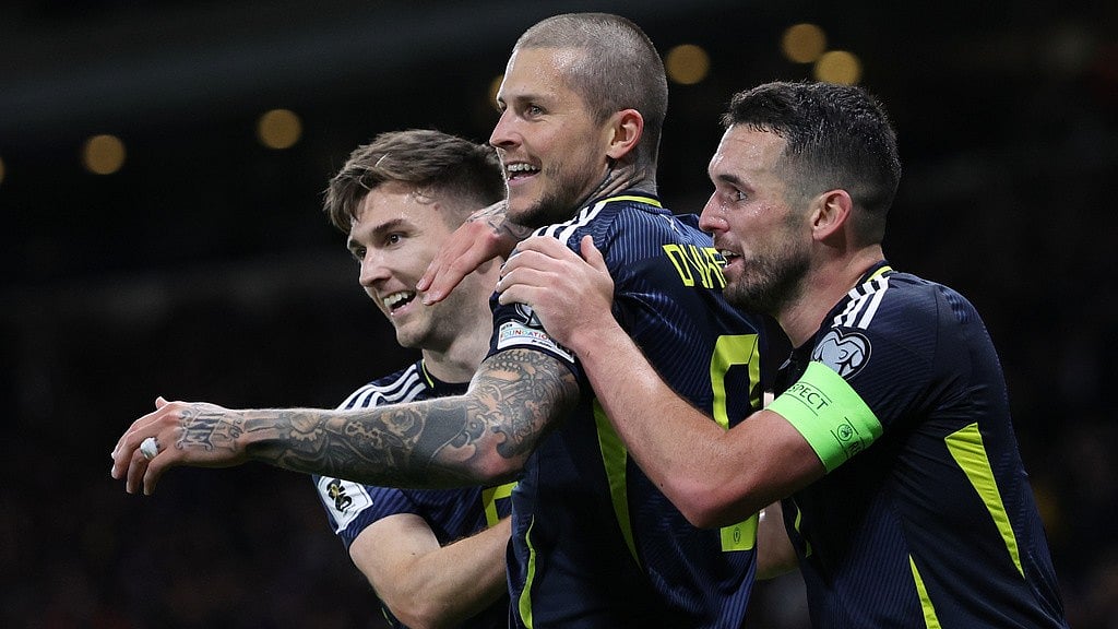 AP : Scotland's Lyndon Dykes, center, celebrates with John McGinn, right, and Kieran Tierney, left, after he scored his side's third goal during the World Cup 2026 group C qualifying match against Greece.