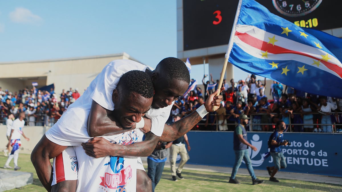 | Photo: AP/Cristiano Barbosa : Cape Verde's Stopira celebrates with his teammate after defeating Eswatini in a World Cup qualifying soccer match at Estádio Nacional in Praia, Cape Verde, Monday, Oct. 13, 2025, to clinch their qualification for the 2026 World Cup.