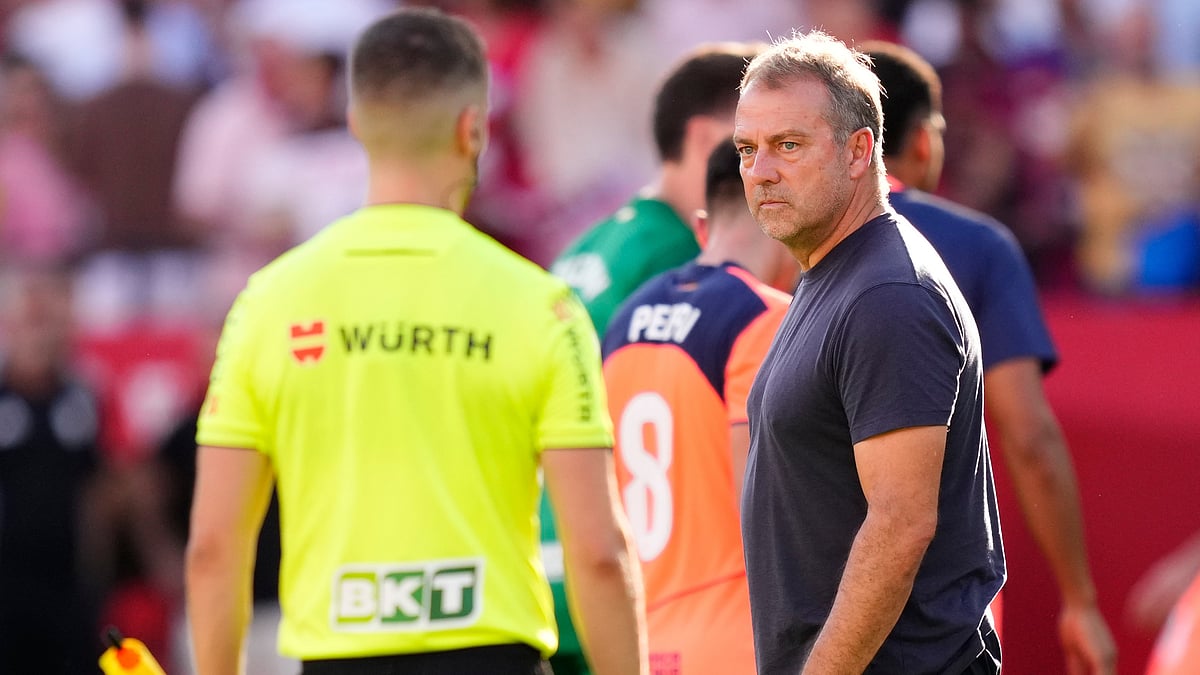 | Photo: AP/Jose Breton : Barcelona's head coach Hansi Flick looks at the referee after the Spanish La Liga soccer match between Sevilla and Barcelona at the Ramon Sanchez Pizjuan stadium in Seville, Spain, Sunday, Oct. 5, 2025
