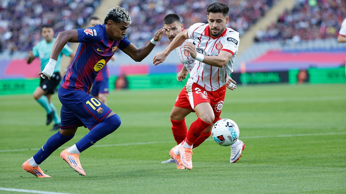 AP/Joan Monfort : Barcelona's Lamine Yamal, left and Girona's Alex Moreno run for the ball during a La Liga soccer match between Barcelona and Girona in Barcelona, Spain.