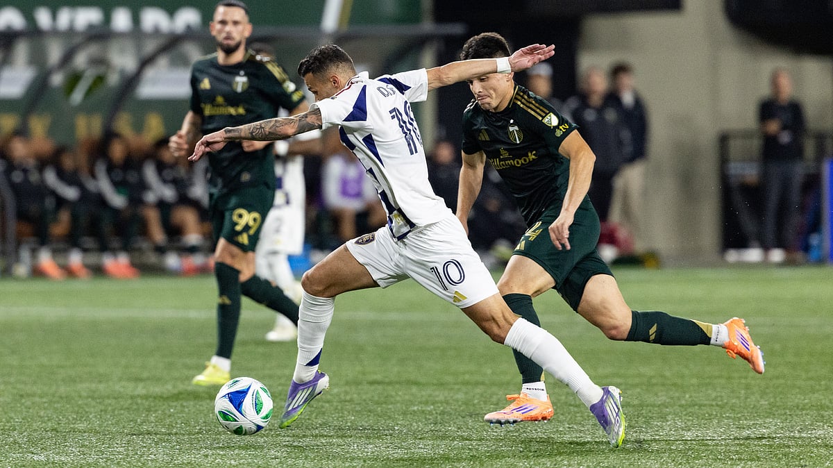 AP/Howard Lao : Diogo Gonçalves, middle, dribbles the ball against Portland Timbers midfielder David Ayala, right, during the first half of an MLS soccer match Wednesday.