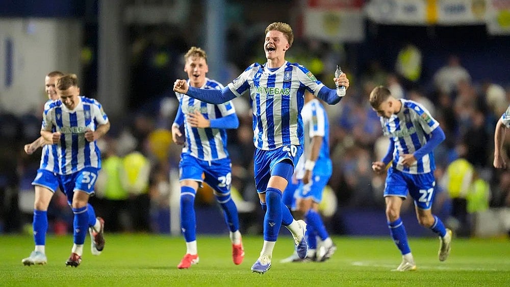 | Photo: Danny Lawson/PA via AP : Sheffield Wednesday players in EFL Cup action.