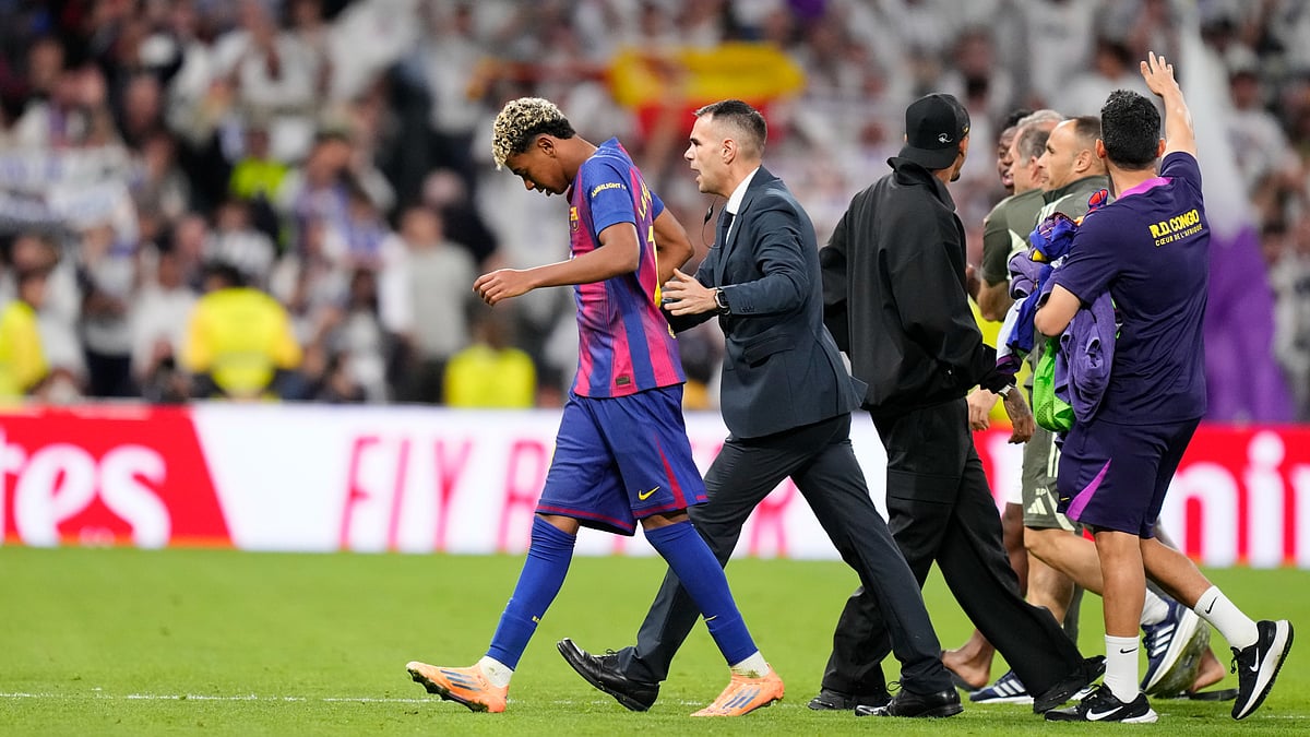 Lamine Yamal is escorted off the field after full-time