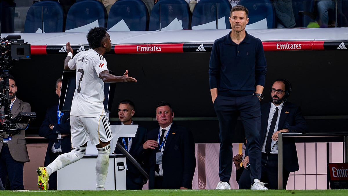 Real Madrid's Vinicius Junior and Xabi Alonso