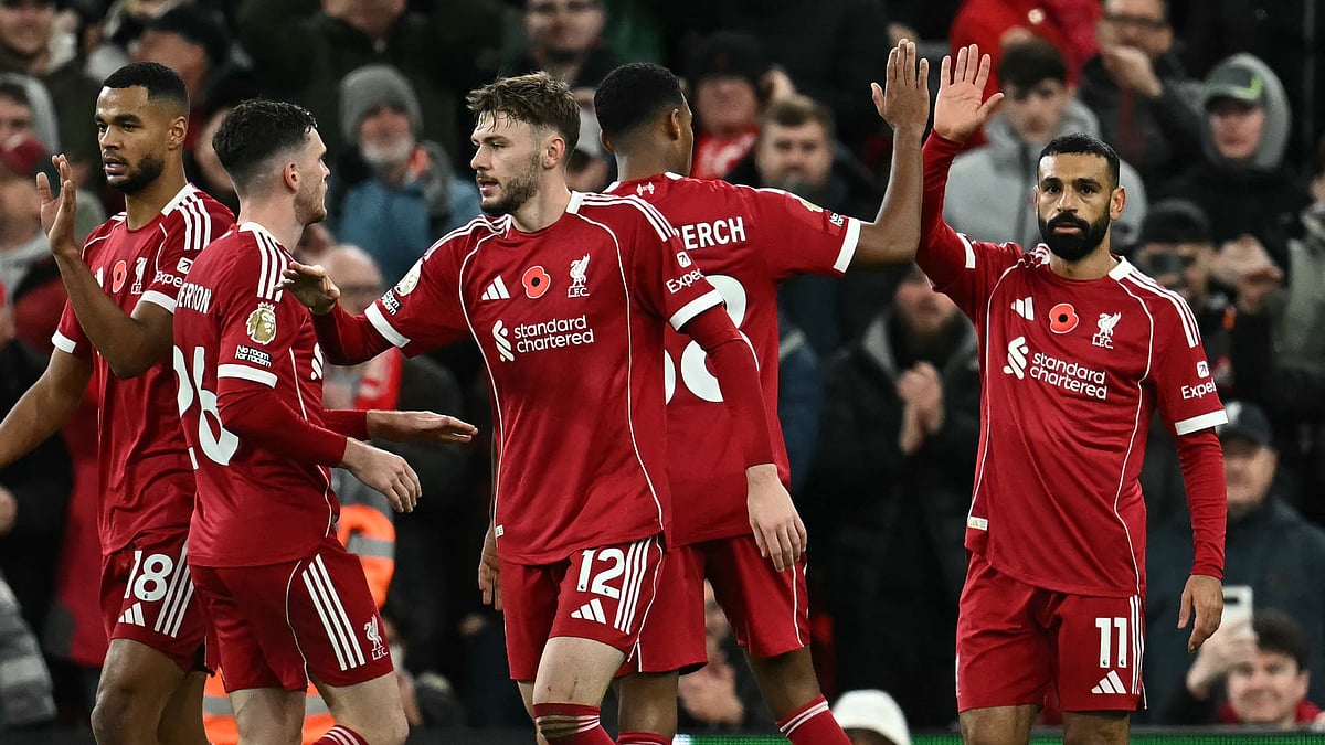 Mohamed Salah celebrates with his Liverpool team-mates after scoring against Aston Villa in English Premier League 2025-26.