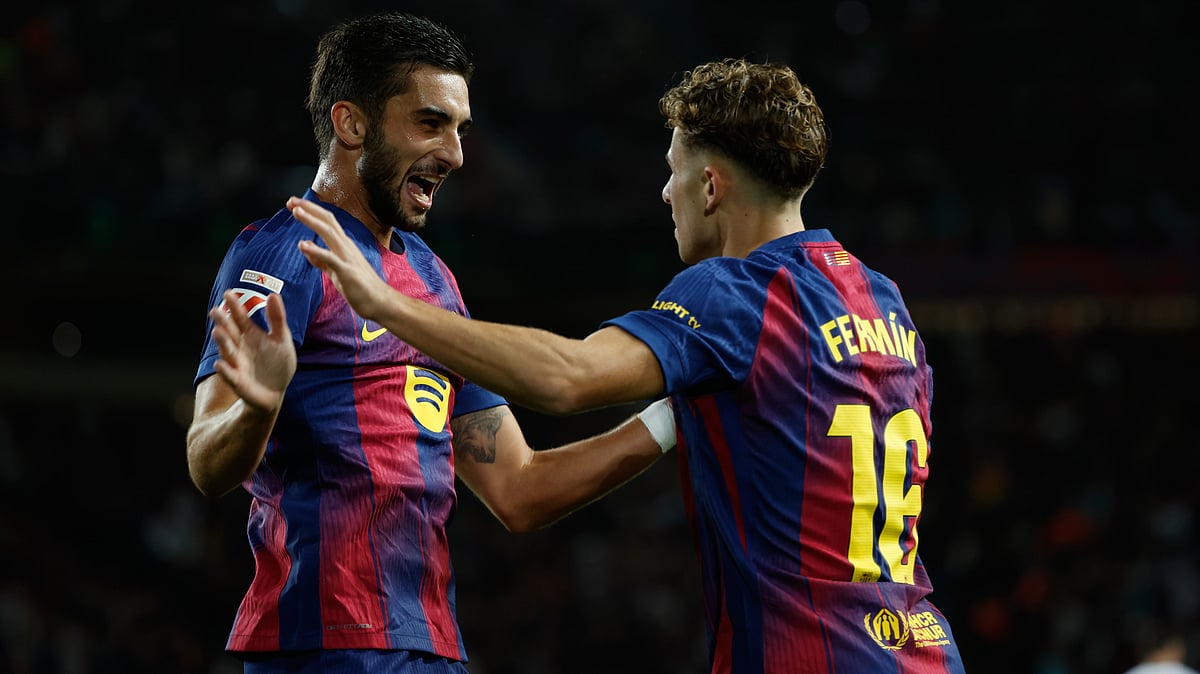 AP/Joan Monfort : Barcelona's Ferran Torres, right, celebrates with his teammate Fermin Lopez after scoring his side's second goal during a Spanish La Liga soccer match
