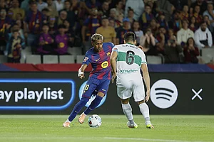 | Photo: AP/Joan Monfort : Barcelona's Lamine Yamal, left, is challenged by Elche's Pedro Bigas during a Spanish La Liga soccer match between FC Barcelona and Elche CF in Barcelona, Spain.