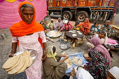 | Photo: PTI/Shiva Sharma : Volunteers prepare langar on the eve of the birth anniversary of founder of Sikhism Guru Nanak Dev, in Amritsar.