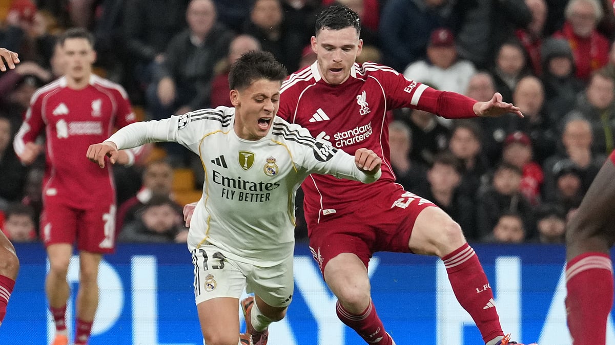 AP/Jon Super : Arda Guler is tackled by Andy Robertson (Right) during Liverpool and Real Madrid in Liverpool, England.