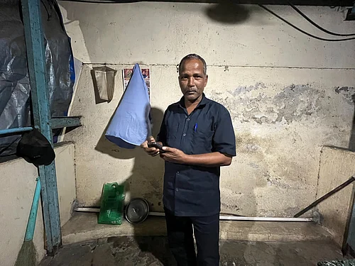Photo - Priyanka Tupe. : Gangaprasad Singh, migrant from Bihars Darbhanga works as a security guard, live in this 70 sq feet cabin. Deepak Darbhangias maithili bhajans help him survive alianation from ballot battle on melancholic nights.