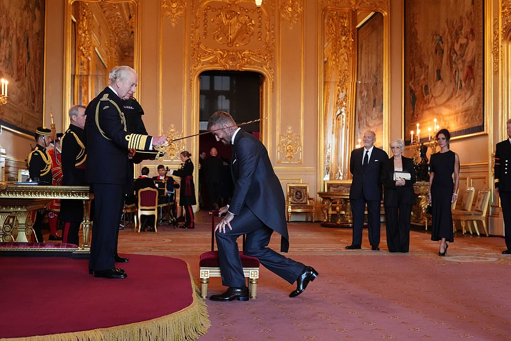 | Photo: Jonathan Brady/PA via AP : Sir David Beckham is made a Knight Bachelor by Britain's King Charles III during an Investiture ceremony at Windsor Castle, Berkshire, England.