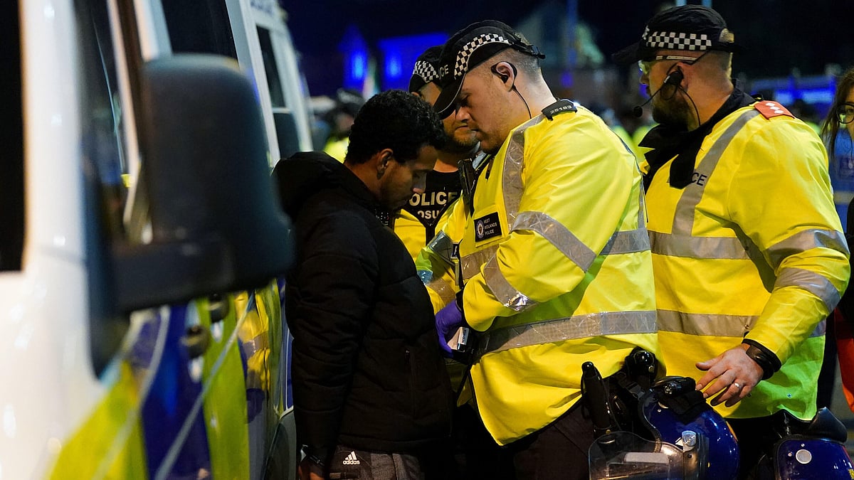 | Photo: AP/Jacob King : Police officers detain a pro-Palestinian protester for setting off a firework in a public place outside Villa Park during the Europa League soccer match between Aston Villa and Maccabi Tel Aviv in Birmingham, England, Thursday, Nov. 6, 2025. 