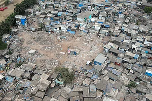 shutterstock : MUMBAI-INDIA - April 10, 2021: Aerial view of demolish slum to upgrade through slum rehabilitation project at Mahim.