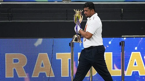 AP : An official removes the winners trophy from the presentation area after India won the Asia Cup cricket final against Pakistan at Dubai International Cricket Stadium.