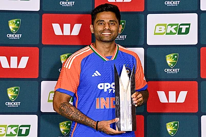 | Photo: PTI/Izhar Khan : Indias captain Suryakumar Yadav poses with the series trophy at the end of the five match T20I cricket series between India and Australia, in Brisbane, Australia. The fifth match got abandoned due to rain and India won the series 2-1.