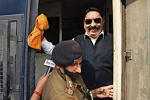 | Photo: Imago/Hindustan times : Land of the gangster-legislator: RJD MLA Anant Singh being detained by a police official on November 25, 2020, in Patna