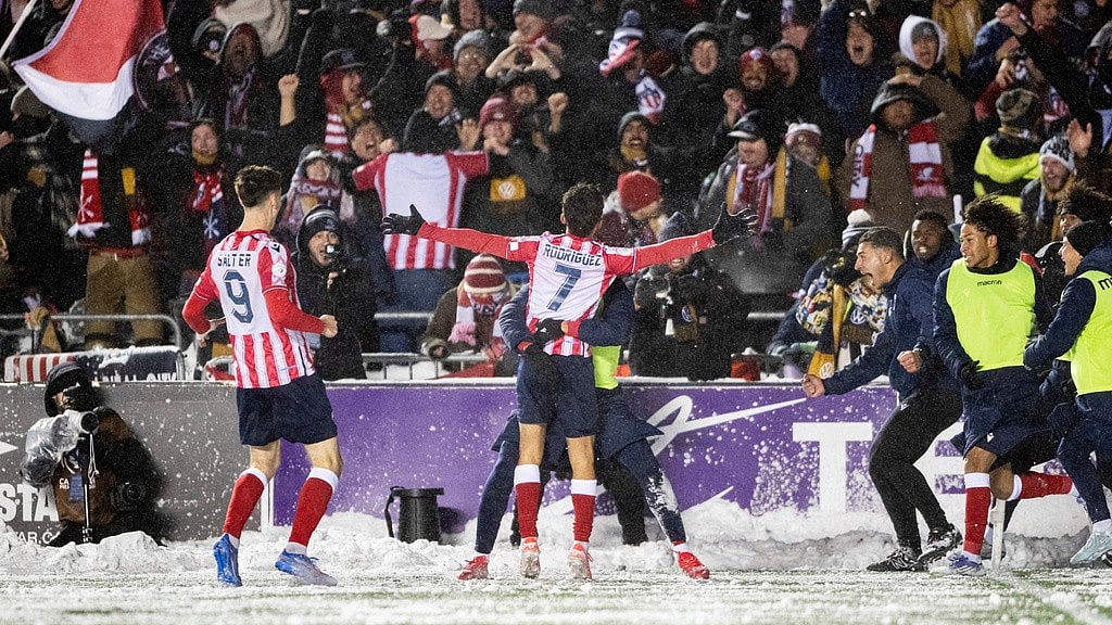 Spencer Colby/The Canadian Press via AP : Atletico Ottawa's David Rodriguez (7) celebrates his with teammates and Atletico fans during the Canadian Premier League final against Cavalry FC.