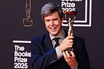 Ian West/AP : Author David Szalay poses for a photo after being named as the winner of the 2025 Booker Prize for the novel Flesh, at Old Billingsgate, in London, Monday, Nov. 10, 2025.