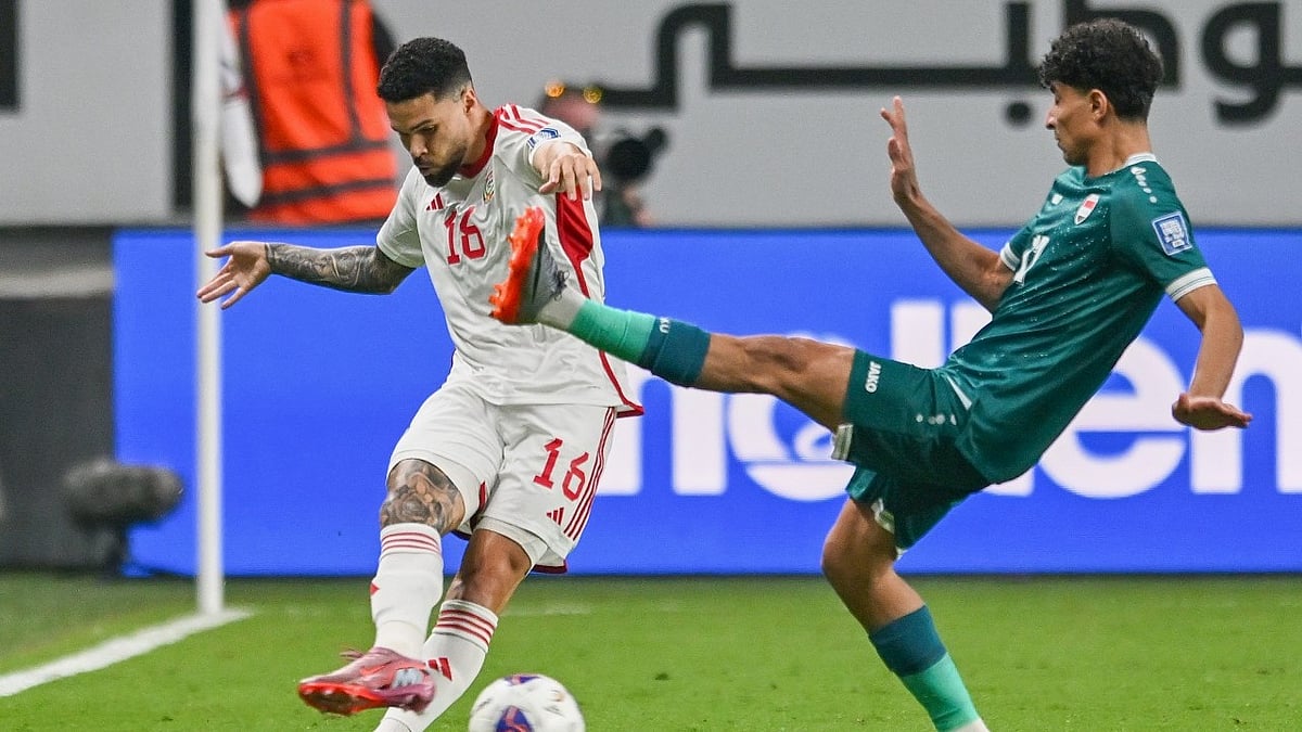 AP Photo : Marcous Vinicius of the UAE, left, passes the ball past Iraqi's Ali Jasim during the 2026 World Cup play off first leg soccer match between UAE and Iraq in Abu Dhabi, United Arab Emirates, Thursday, Nov. 13, 2025