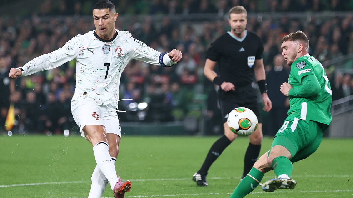 AP/Peter Morrison : Jack Taylor, right, tries to block a shot from Portugal's Cristiano Ronaldo during a World Cup 2026 group F qualifying soccer match.