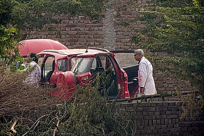 | Photo: PTI : Central Forensic Science Laboratory (CFSL) officials at the site after a red Ford EcoSport car suspected to be linked to the Delhi Red Fort blast case was traced and seized in Faridabad districts Khandawali.