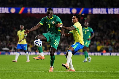 | Photo: John Walton/PA via AP : Senegals Antoine Mendy, left, and Brazils Rodrygo battle for the ball during an international soccer match between Brazil and Senegal at the Emirates Stadium, London.