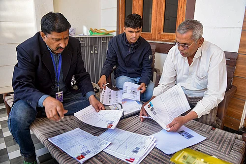 | Photo: PTI : Booth Level Officers (BLOs) assist a voter in filling out the enumeration form for the special intensive revision (SIR) of electoral rolls, in Bikaner, Rajasthan.