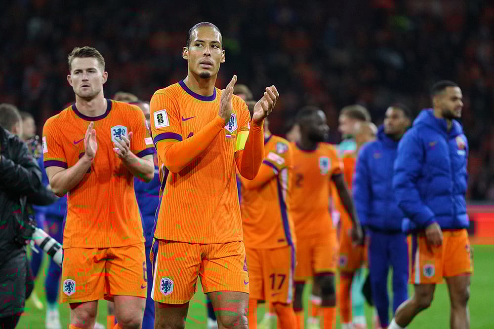 | Photo: AP/Peter Dejong : Netherlands' Virgil van Dijk, front, and teammates celebrate after a World Cup 2026 group G qualifying soccer match between Netherlands and Lithuania in Amsterdam, Netherlands.
