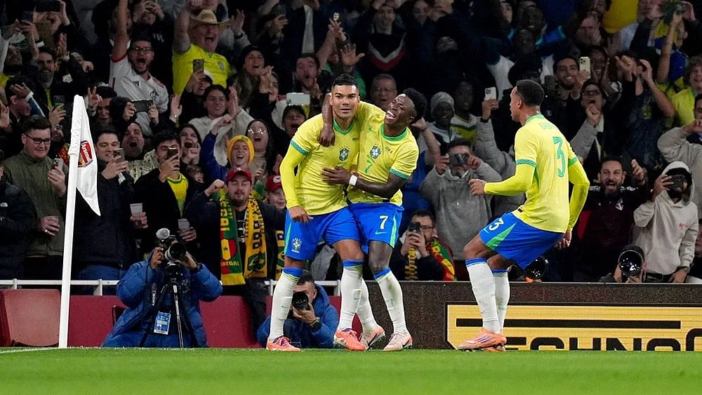 | Photo: John Walton/PA via AP : Brazil's Casemiro, left, celebrates scoring their side's second goal of the game during an international soccer match between Brazil and Senegal at the Emirates Stadium, London.