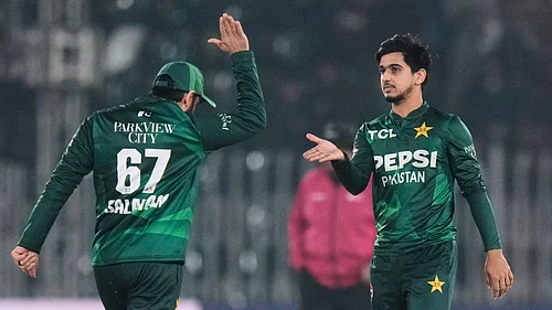 (AP Photo/Anjum Naveed) : Pakistans Saim Ayub, right, celebrates with teammate after taking the wicket of Zimbabwes Brian Bennett during the tri-series T20 cricket match between Pakistan and Zimbabwe, in Rawalpindi, Pakistan, Tuesday, Nov. 18, 2025.