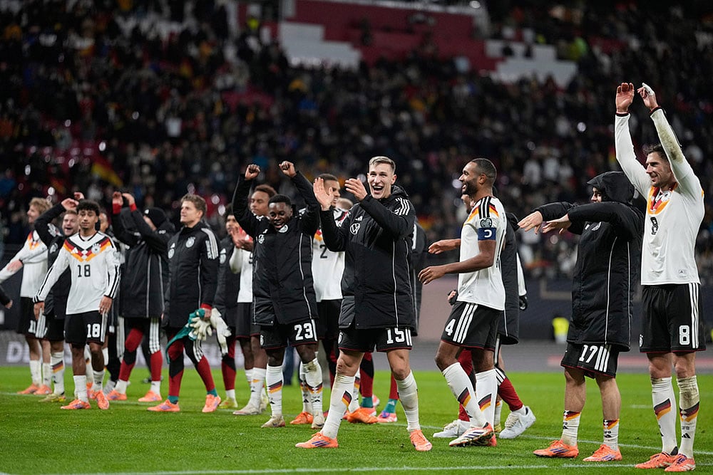 | Photo: AP/Matthias Schrader : German players celebrate qualifying for the World Cup after beating Slovakia in Leipzig, Germany.
