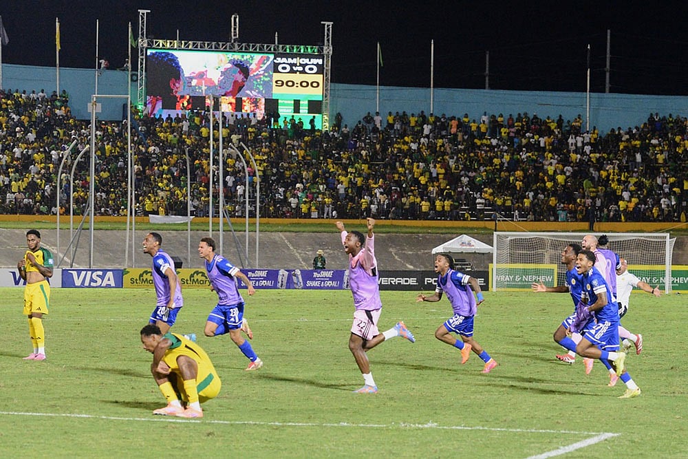 | Photo: AP/Collin Reid : Curaçao players celebrate qualifying for the 2026 FIFA World Cup after a soccer match against Jamaica in Kingston, Jamaica.