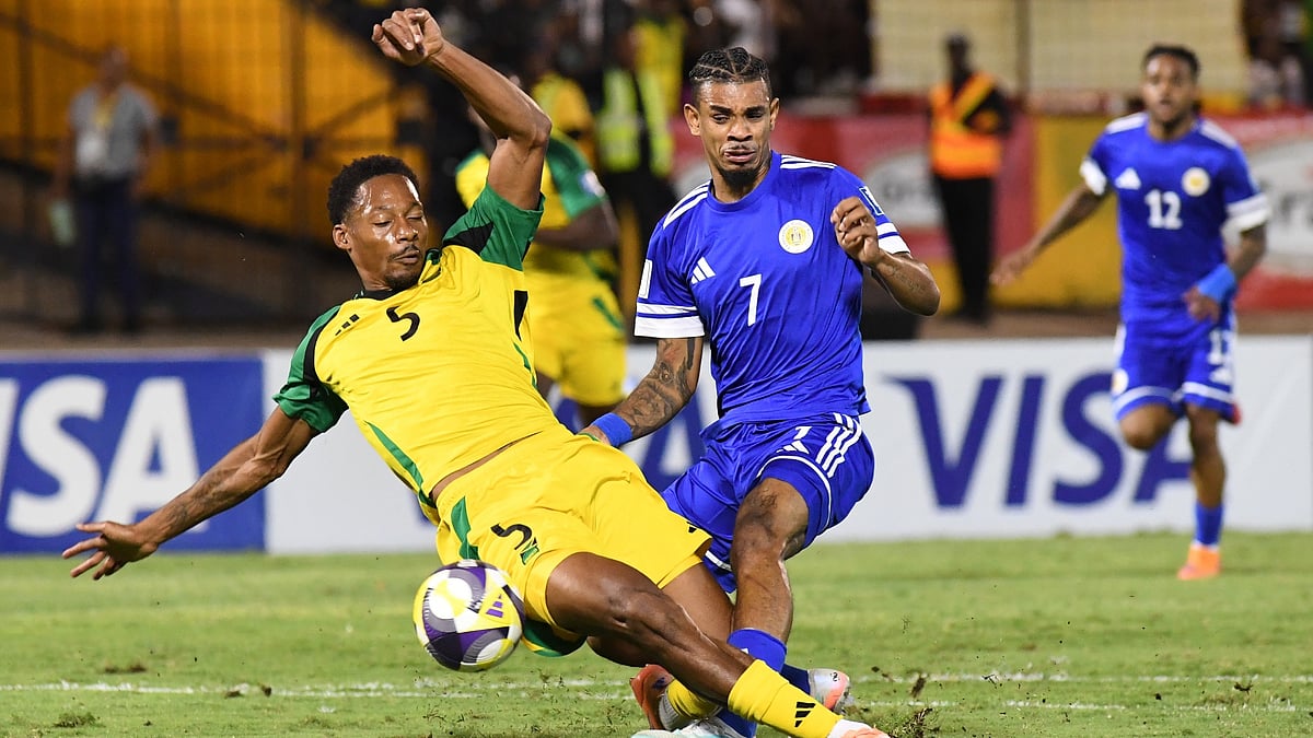 AP Photo/Collin Reid : Curaçao's Juninho Bacuna, center, fight for the ball against Jamaica's Ethan Pinnock, left, during a World Cup 2026 qualifying soccer match in Kingston, Jamaica, Tuesday, Nov. 18, 2025