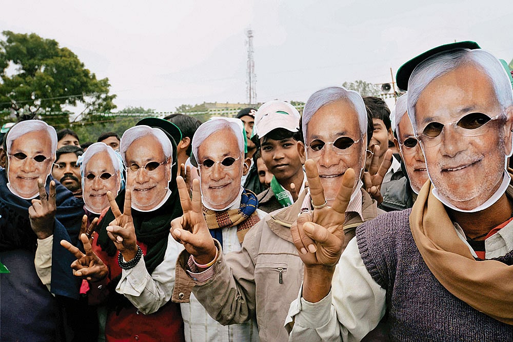 | Photo: PTI : The Loyalists: JD(U) supporters wearing masks of Nitish Kumar at a rally in Gaya