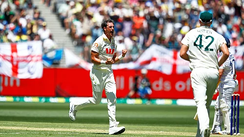 (AP Photo/Gary Day) : Australias Mitchell Starc, left, celebrates the wicket of Englands Ben Duckett during the first Ashes cricket test match between Australia and England in Perth, Friday, Nov. 21, 2025.