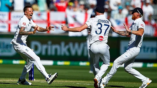 AP : Englands Brydon Carse, left, celebrates with teammates Ben Stokes and Gus Atkinson the wicket of Australias Usman Khawaja during the first Ashes Test.