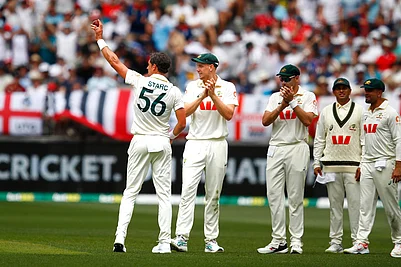 | Photo: AP/Gary Day : Australias Mitchell Starc, left, lifts the ball to acknowledge his tenth wicket in the first Ashes cricket test match between Australia and England in Perth.