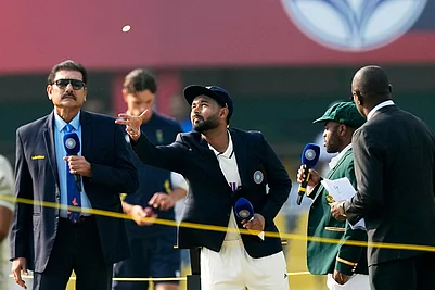 | Photo: AP/Anupam Nath : Indias captain Rishabh Pant, centre, flip the coin for the toss as South Africas captain Temba Bavuma watches before start the first day of the second cricket test match between India and South Africa in Guwahati.