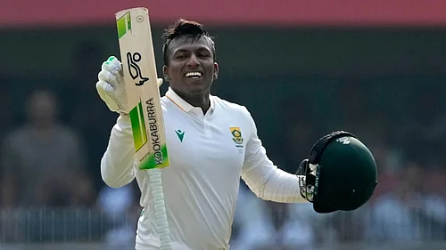 Photo: AP/Anupam Nath : South Africas Senuran Muthusamy celebrates after scoring a century on the second day of the second cricket test match between India and South Africa in Guwahati.