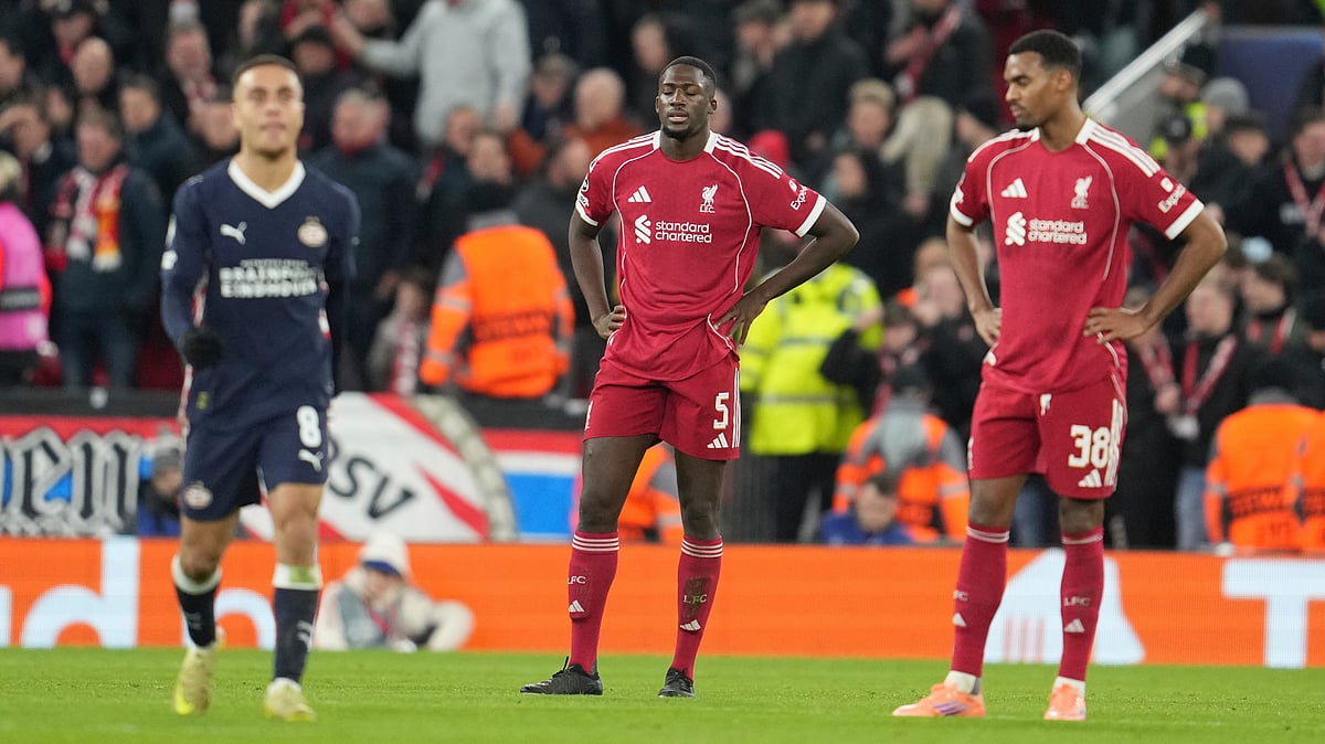 (AP Photo/Jon Super) : Liverpool's Ibrahima Konate, centre, and Ryan Gravenberch, right, react after PSV's Couhaib Driouech scored his side's third goal during the Champions League opening phase soccer match between Liverpool and PSV in Liverpool, England, Wednesday, Nov. 26, 2025