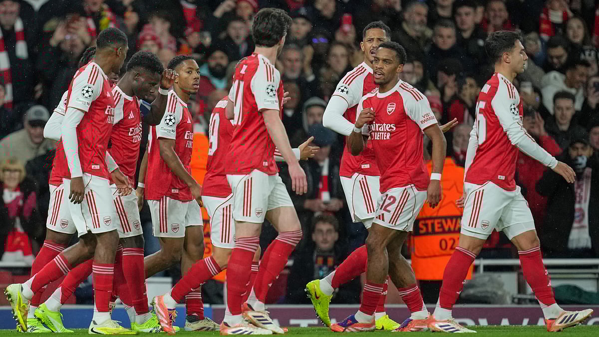| Photo: AP/Kin Cheung : Arsenal's Jurrien Timber celebrates with teammates after scoring the opening goal during the UEFA Champions League opening phase match against Bayern Munich on November 26, 2025.
