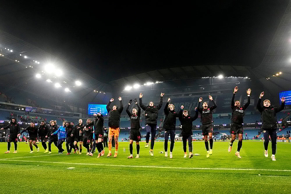 | Photo: Nick Potts/PA via AP : Bayer Leverkusen players celebrate after the Champions League opening phase soccer match between Manchester City and Bayer Leverkusen in Manchester, England.