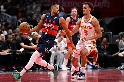 | Photo: AP/John McDonnell : Washington Wizards guard CJ McCollum (3) looks to pass off against Atlanta Hawks guard Dyson Daniels during the second half of a Emirates NBA Cup basketball game in Washington.