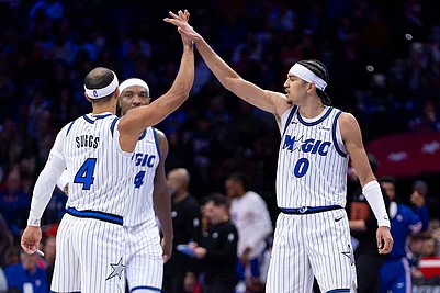| Photo: AP/Chris Szagola : Orlando Magics Anthony Black, right, celebrates with Jalen Suggs, left, and Wendell Carter Jr., center, during the first half of an NBA Cup basketball game against the Philadelphia 76ers in Philadelphia.